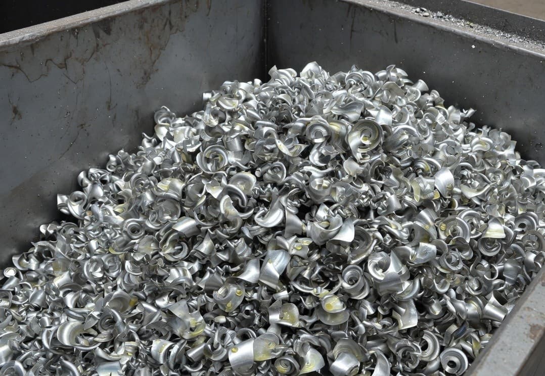 A bin of curly silver aluminium machining turnings