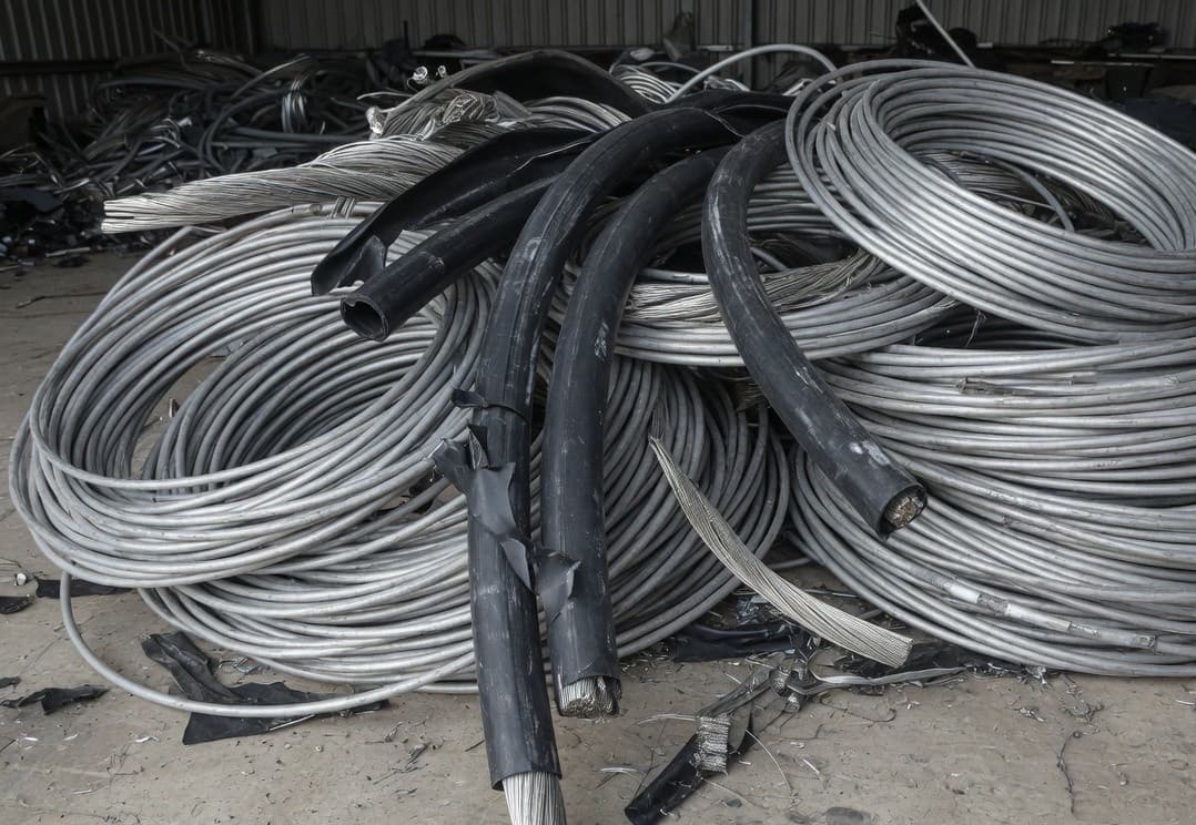 Coils of silver aluminium cable with black insulation peeled back
